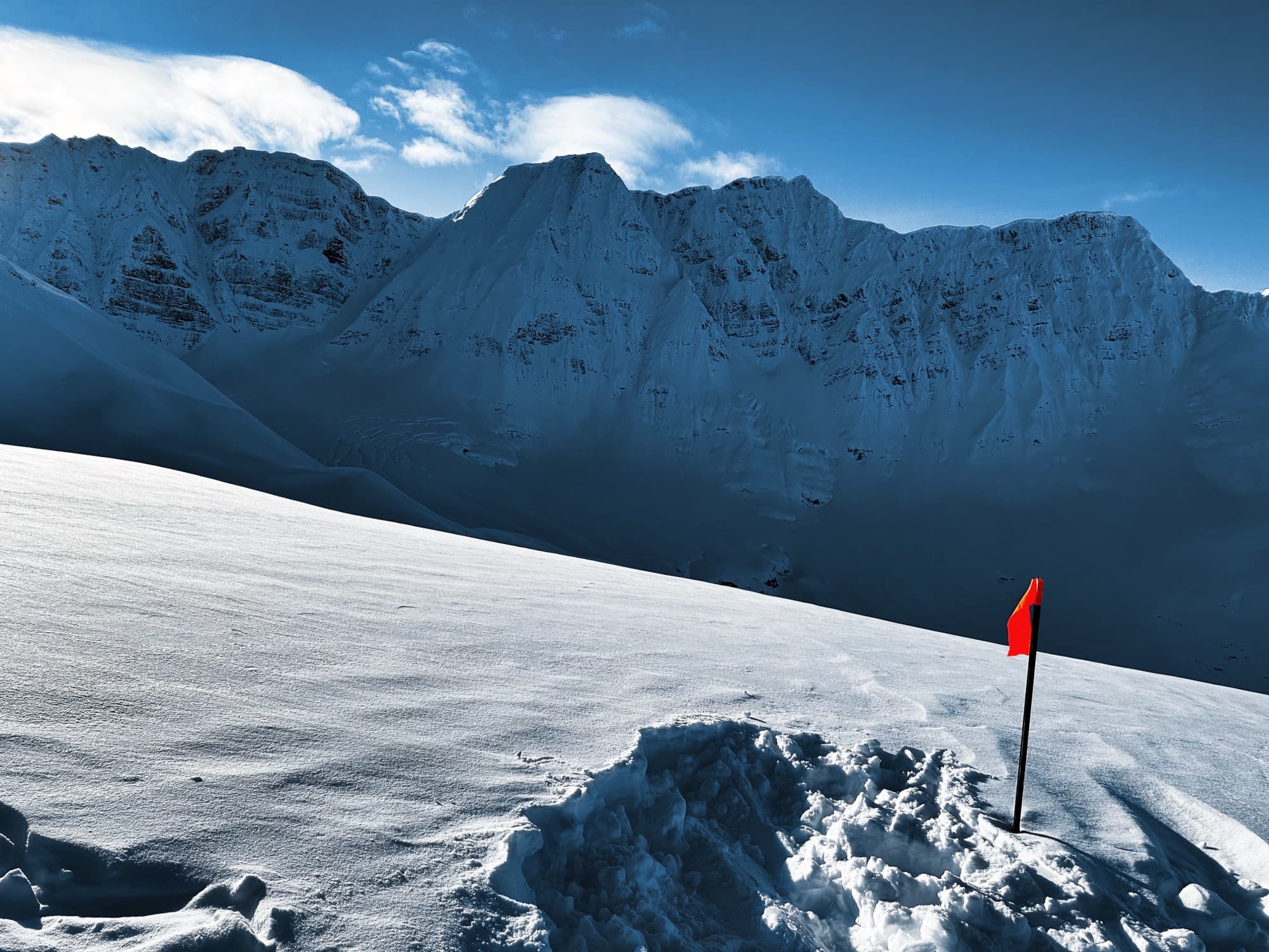 Steep couloir descent through untouched snow