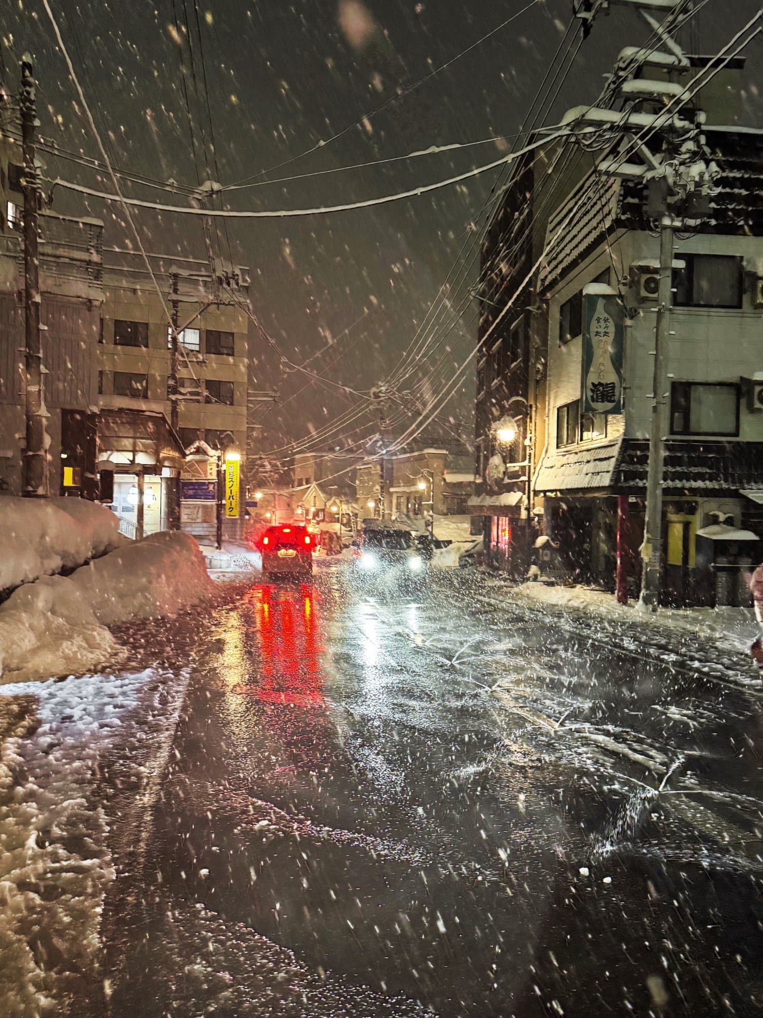 Snow-covered village street at night