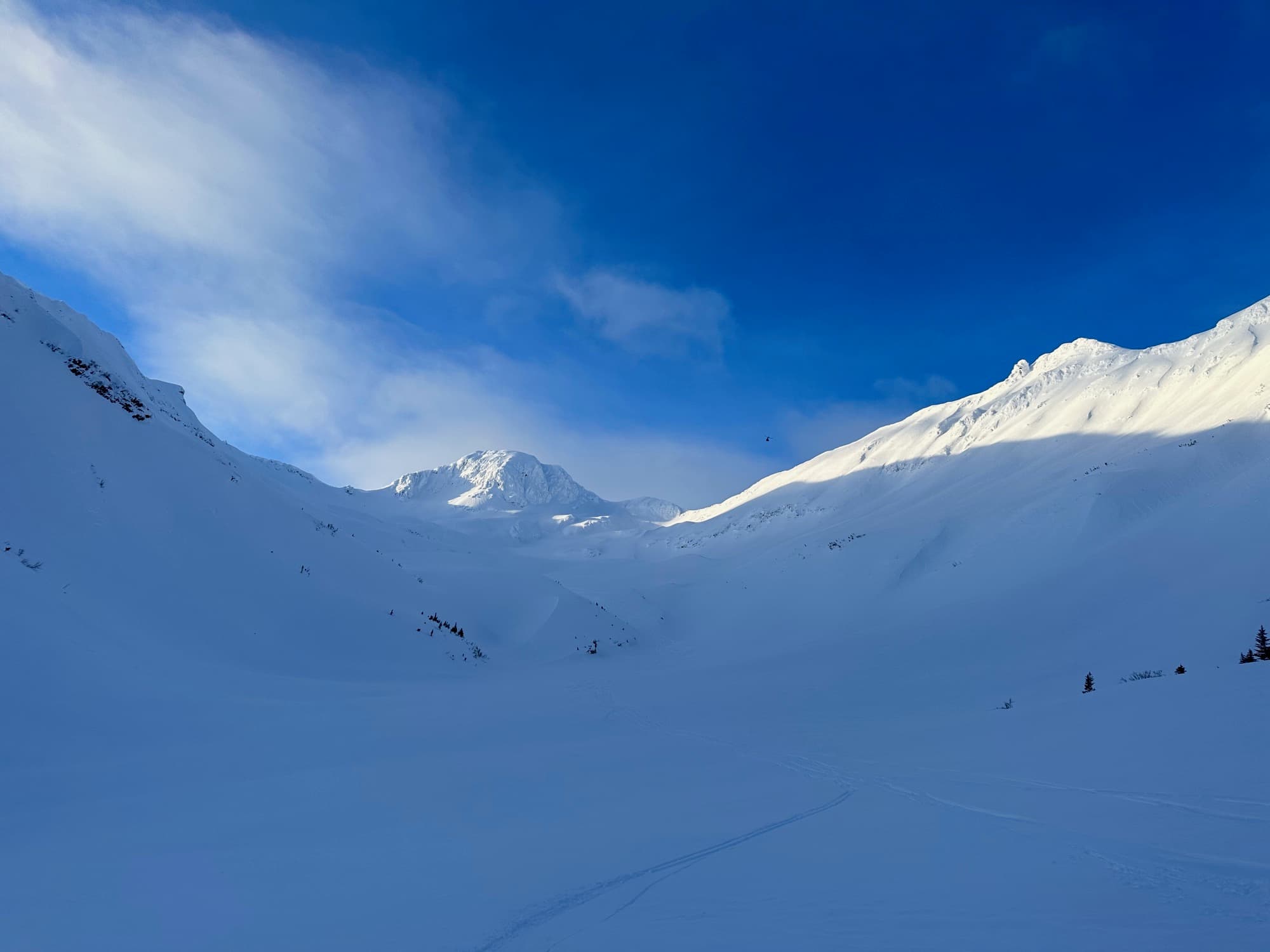 High-altitude cloudscape over snow-covered ridgeline