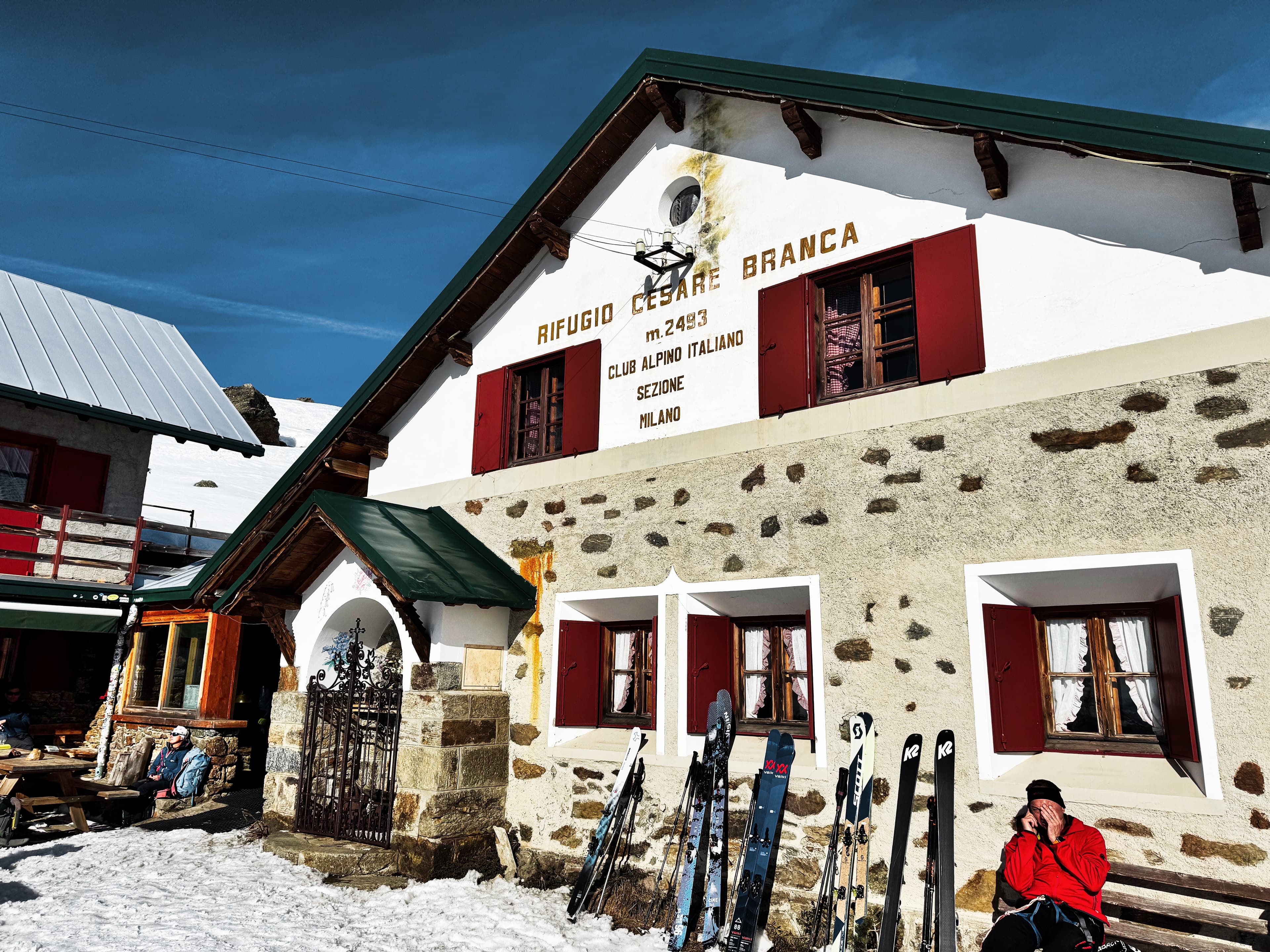 Rifugio Cesare Branca at 2,493m, Club Alpino Italiano, skiers resting outside